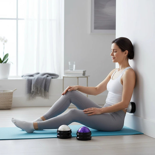 Pure Motion massage ball in white and purple, used by a woman sitting against a wall for back relief.