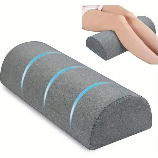 Pure Motion grey memory foam knee pillow with semi-roll shape for leg and lumbar support.