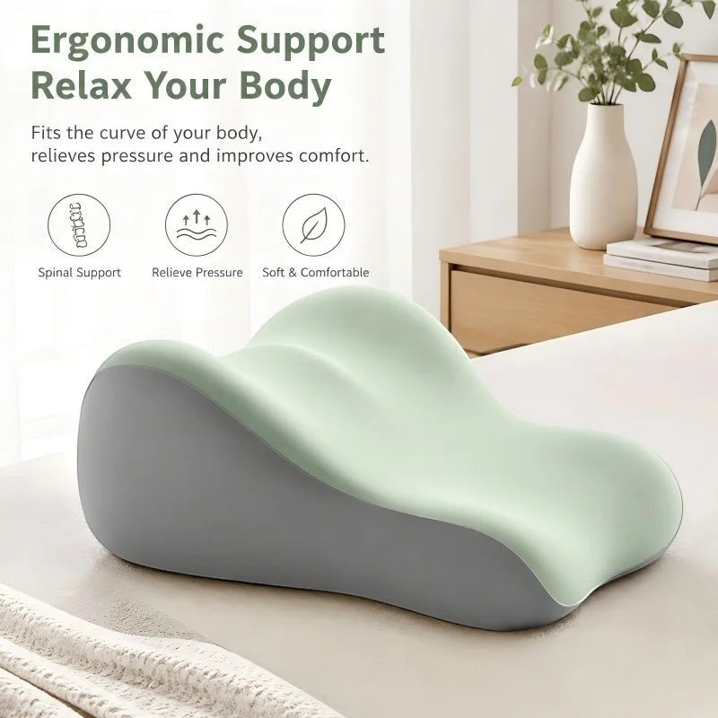 Pure Motion memory foam leg elevation pillow in light green and gray, designed for ergonomic support and comfort.