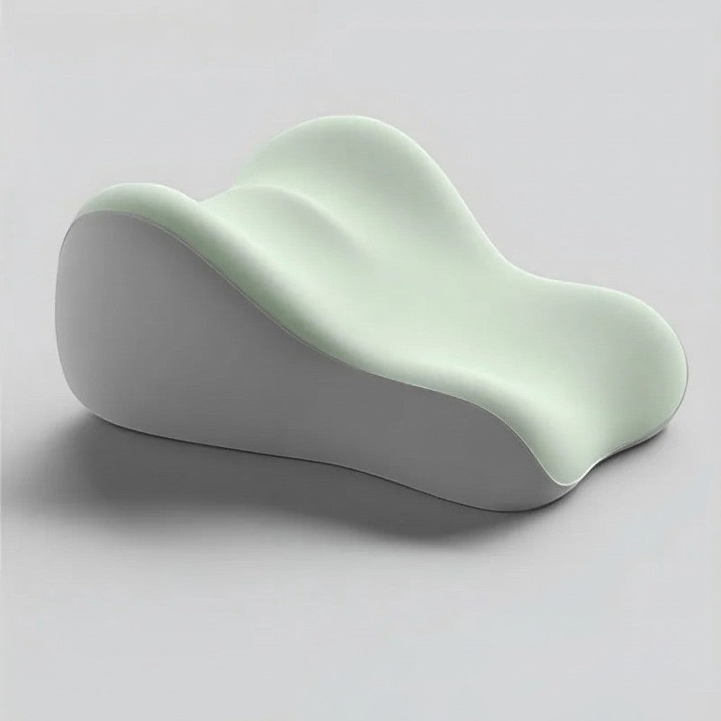 Pure Motion memory foam leg elevation pillow in light green with an ergonomic contoured design for recovery and rest.